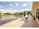 Scenic patio overlooking a tranquil lake, complete with comfortable seating and picturesque views at 1711 Gondola Park Dr # 1711, Venice, FL 34292
