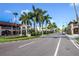 Charming street view with lush palm trees, a welcome sign, and well-maintained landscaping at 1711 Gondola Park Dr # 1711, Venice, FL 34292