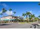 Picturesque street view featuring palm trees and colorful buildings with awnings in a vibrant setting at 1711 Gondola Park Dr # 1711, Venice, FL 34292