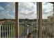Breathtaking view from the balcony showcasing lush greenery, a tranquil lake, and clear blue skies above at 1711 Gondola Park Dr # 1711, Venice, FL 34292
