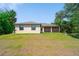 Spacious backyard featuring a screened patio and lush green lawn at 172 Berthoud St, Port Charlotte, FL 33953