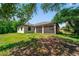 Expansive backyard featuring a screened patio, lush grass, and mature trees at 172 Berthoud St, Port Charlotte, FL 33953