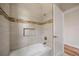 Beautiful bathroom with tiled walls, a built in shower shelf, and white door with chrome hardware at 172 Berthoud St, Port Charlotte, FL 33953