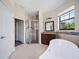 Bright bathroom with a soaking tub, shower, and modern fixtures with natural stone at 172 Berthoud St, Port Charlotte, FL 33953