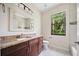 Bathroom featuring granite countertops, wood cabinets, and tile flooring at 172 Berthoud St, Port Charlotte, FL 33953