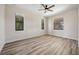 Bright and spacious bedroom with laminate flooring, ceiling fan, and three windows for lots of natural light at 172 Berthoud St, Port Charlotte, FL 33953