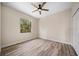 Bedroom featuring wood flooring, a ceiling fan, and a sunny window at 172 Berthoud St, Port Charlotte, FL 33953