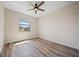 Bright bedroom with wood floors, a ceiling fan, and a sun-filled window at 172 Berthoud St, Port Charlotte, FL 33953
