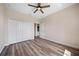 Bedroom with wood floors, ceiling fan, closet, and neutral paint at 172 Berthoud St, Port Charlotte, FL 33953