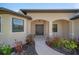 Elegant entryway featuring a double door, manicured landscaping, and an arched portico at 172 Berthoud St, Port Charlotte, FL 33953