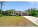 Charming single-story home with a well-manicured lawn and attached two car garage at 172 Berthoud St, Port Charlotte, FL 33953