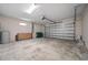 Spacious two car garage with concrete flooring and paneled garage door at 172 Berthoud St, Port Charlotte, FL 33953