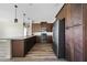 Modern kitchen with stainless steel appliances, brown cabinets, granite countertops, and laminate flooring at 172 Berthoud St, Port Charlotte, FL 33953