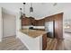 Modern kitchen features granite countertops, stainless steel appliances, brown cabinets, and laminate flooring at 172 Berthoud St, Port Charlotte, FL 33953