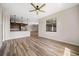 Open floor plan that features the living room connected to the kitchen with laminate flooring and natural light at 172 Berthoud St, Port Charlotte, FL 33953