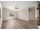 Spacious living room with wood laminate floors and large windows for ample natural light at 172 Berthoud St, Port Charlotte, FL 33953