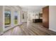 Open floor plan with wood laminate floors, and open access to a kitchen and lanai at 172 Berthoud St, Port Charlotte, FL 33953