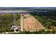 Expansive land parcel featuring a home, pond, and boat, outlined by a white property border at 1727 E Manasota Beach Rd, Englewood, FL 34223