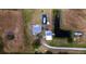 Birds-eye view of property, including a home, boat, pond, and vehicles, set on a large lot at 1727 E Manasota Beach Rd, Englewood, FL 34223