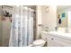 Bathroom features a shower with blue sea-themed shower curtain at 1727 E Manasota Beach Rd, Englewood, FL 34223