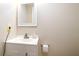 Modern bathroom featuring white vanity, modern faucet and fixtures, with mirror at 1727 E Manasota Beach Rd, Englewood, FL 34223