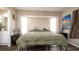 Bedroom with a bay window, bedside tables and lamps at 1727 E Manasota Beach Rd, Englewood, FL 34223