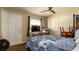 Comfortable bedroom with a ceiling fan, closet, and blue and white comforter at 1727 E Manasota Beach Rd, Englewood, FL 34223