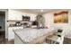 Kitchen with stainless steel appliances, granite countertops, and white cabinetry at 1727 E Manasota Beach Rd, Englewood, FL 34223