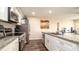 Kitchen featuring stainless steel appliances, granite countertops, and a view to living room at 1727 E Manasota Beach Rd, Englewood, FL 34223