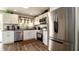 Modern kitchen with stainless steel appliances, white cabinetry, and granite countertops at 1727 E Manasota Beach Rd, Englewood, FL 34223