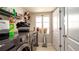 Well-equipped laundry room with modern appliances, storage shelves and a window for natural light at 1727 E Manasota Beach Rd, Englewood, FL 34223
