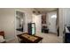 Open living area with modern lighting, a decorative painting, and access to other rooms at 1727 E Manasota Beach Rd, Englewood, FL 34223