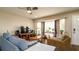 Bright living room featuring comfortable seating, a ceiling fan, and a large window for plenty of natural light at 1727 E Manasota Beach Rd, Englewood, FL 34223