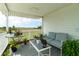 Covered patio with seating offers a relaxing outdoor space with a view of the surrounding landscape at 1727 E Manasota Beach Rd, Englewood, FL 34223