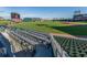 View of a baseball field from stadium seating, featuring well-maintained field, and stadium with a clear blue sky at 18002 Franklin Park Ct, Venice, FL 34293