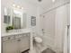 Bright bathroom with white marble floors, gray vanity with white countertop, and a shower and tub combination at 18002 Franklin Park Ct, Venice, FL 34293