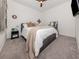 Cozy bedroom features a ceiling fan, comfy carpet, and a large bed with a plush blanket and throw pillows at 18002 Franklin Park Ct, Venice, FL 34293