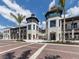 Unique commercial property showcasing a stylish exterior with pedestrian-friendly walkways and palm tree accents at 18002 Franklin Park Ct, Venice, FL 34293
