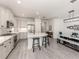 Modern kitchen featuring white cabinets, stainless steel appliances, a large island, and an open layout with the dining area at 18002 Franklin Park Ct, Venice, FL 34293