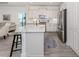 Bright kitchen features white cabinetry, stainless steel appliances, and quartz countertops with a breakfast bar at 18002 Franklin Park Ct, Venice, FL 34293