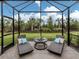 Open screened-in lanai showcasing outdoor seating, lounge chairs, and string lights at 18002 Franklin Park Ct, Venice, FL 34293