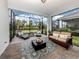 Screened lanai featuring a conversation set, daybeds and an outdoor rug at 18002 Franklin Park Ct, Venice, FL 34293