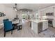 Open floor plan shows the dining room, kitchen, and living area all connected, filled with natural light at 18002 Franklin Park Ct, Venice, FL 34293