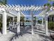 Inviting community pool with covered patio area offering seating and shade on a sunny day at 18002 Franklin Park Ct, Venice, FL 34293