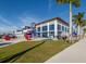 Modern baseball team store building with large windows, red accents and a well-manicured lawn and paved sidewalk at 18002 Franklin Park Ct, Venice, FL 34293
