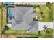 Aerial shot of a meticulously maintained home with a screened pool, set on a well-manicured lot at 194 Sportsman Rd, Rotonda West, FL 33947