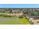 Scenic aerial view of a community with a serene lake, lined by lush trees and inviting homes at 194 Sportsman Rd, Rotonda West, FL 33947
