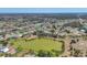 An aerial view of a community with single Gathering homes, a lake, and picturesque landscaping at 194 Sportsman Rd, Rotonda West, FL 33947