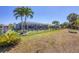 Lush backyard with a screened pool, ideal for relaxation and entertaining, surrounded by tropical palm trees at 194 Sportsman Rd, Rotonda West, FL 33947