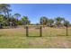 Spacious backyard with a chain-link fence, offering a secure area for outdoor activities at 194 Sportsman Rd, Rotonda West, FL 33947